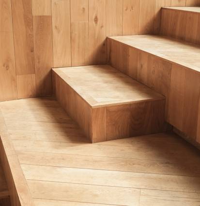 Abstract empty interior fragment, natural wooden stairs. Photo with selective focus